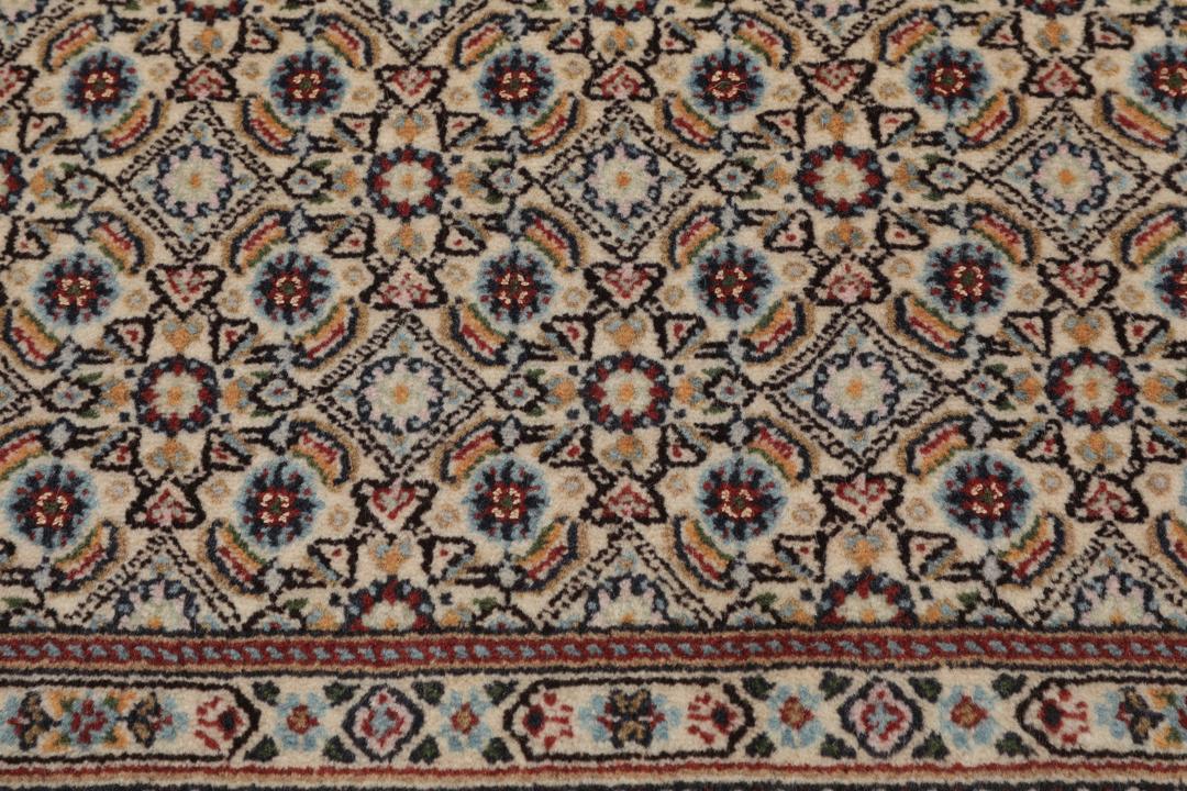 A hand-knotted Moud runner rug with a floral design in multicolor tones
