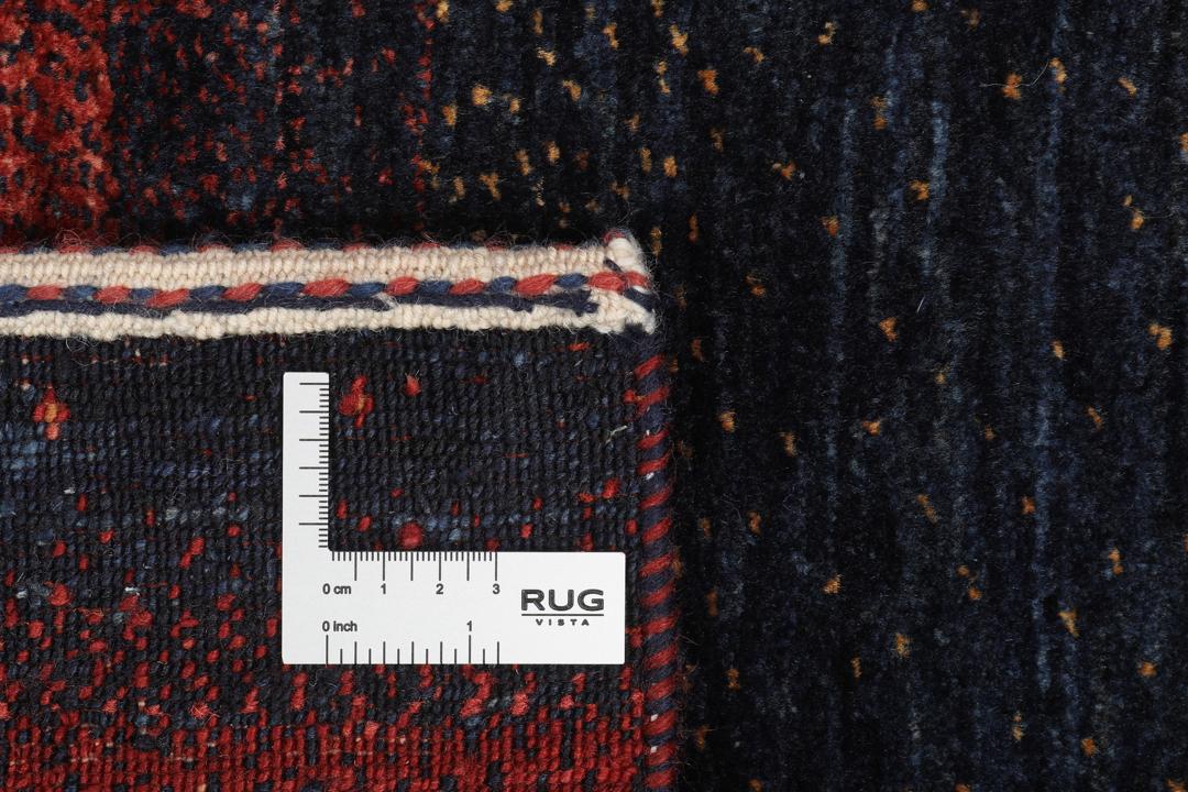Hand-knotted Loribaft rug from the Middle East in deep red and dark-blue tones.