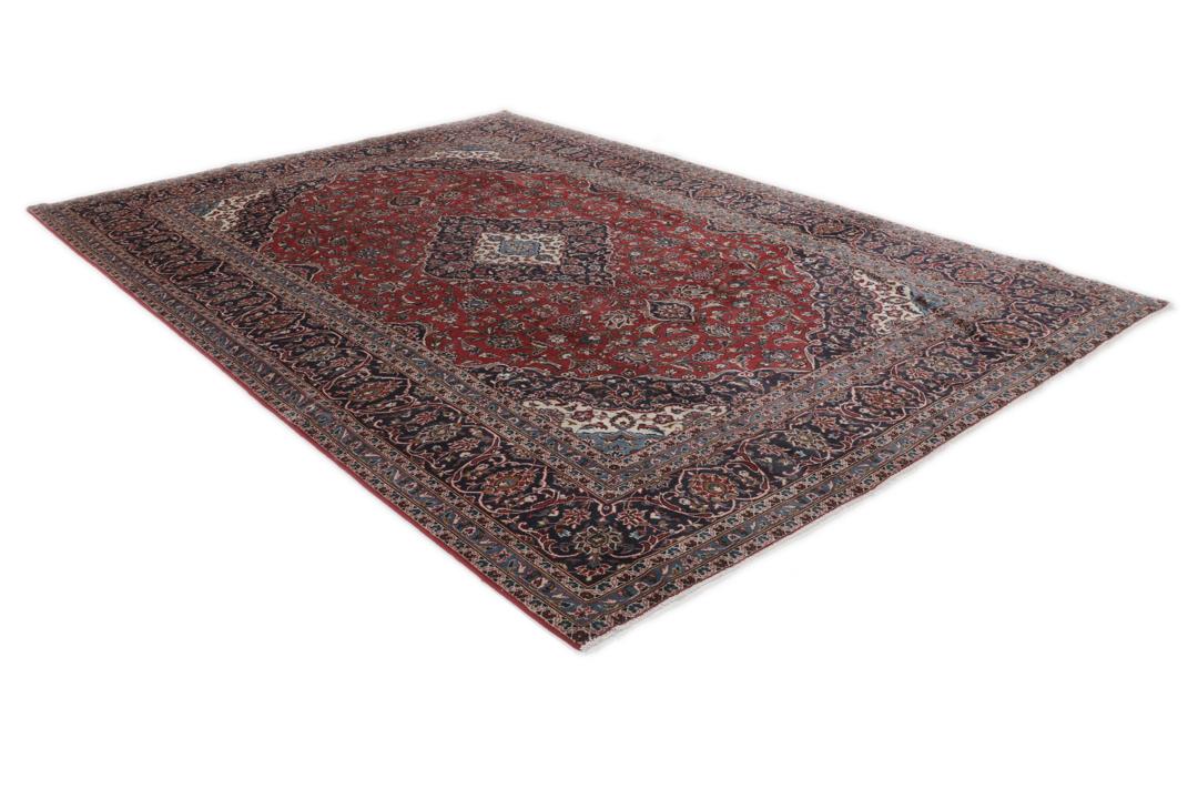 A hand-knotted Keshan rug from the Middle East with a red and dark-blue medallion pattern.
