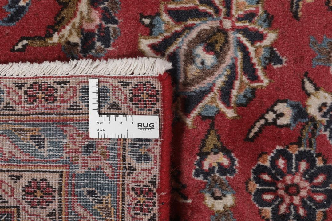 A hand-knotted Keshan rug from the Middle East with a red and dark-blue medallion pattern.
