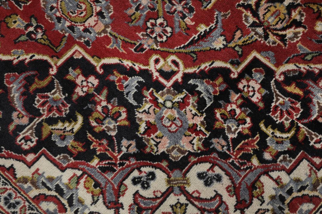 Hand-knotted Keshan rug from the Middle East in deep red and black