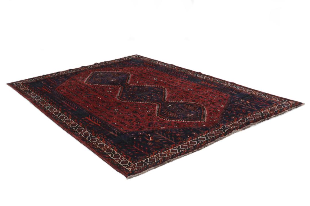 Hand-knotted Shiraz rug featuring deep blue and red tribal patterns