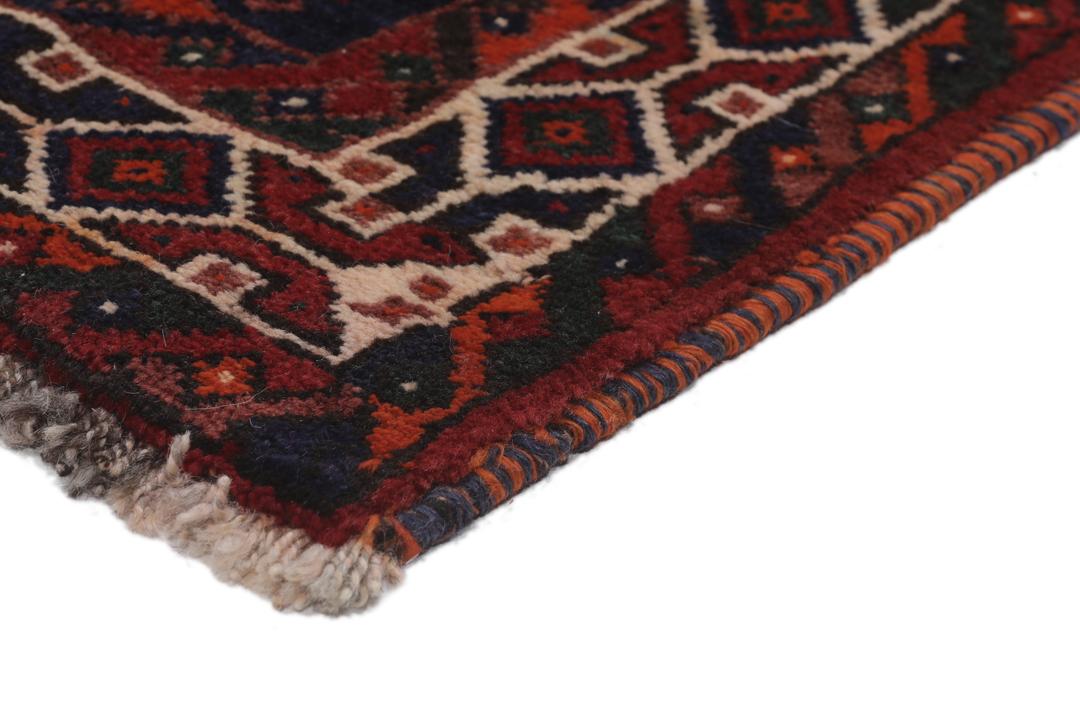 Hand-knotted Shiraz rug featuring deep blue and red tribal patterns