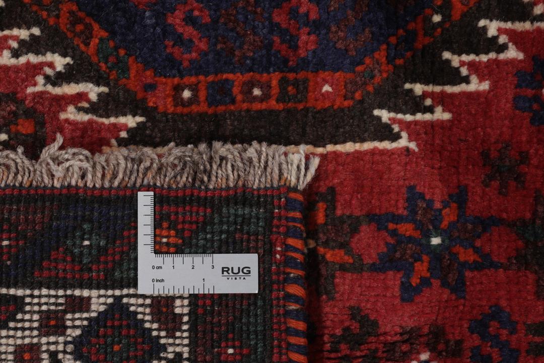Hand-knotted Shiraz rug featuring deep blue and red tribal patterns