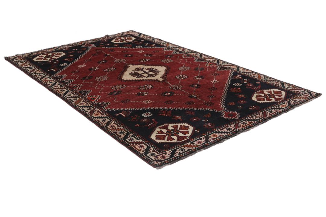Hand-knotted Shiraz rug from the Middle East in dark-red and black tones.