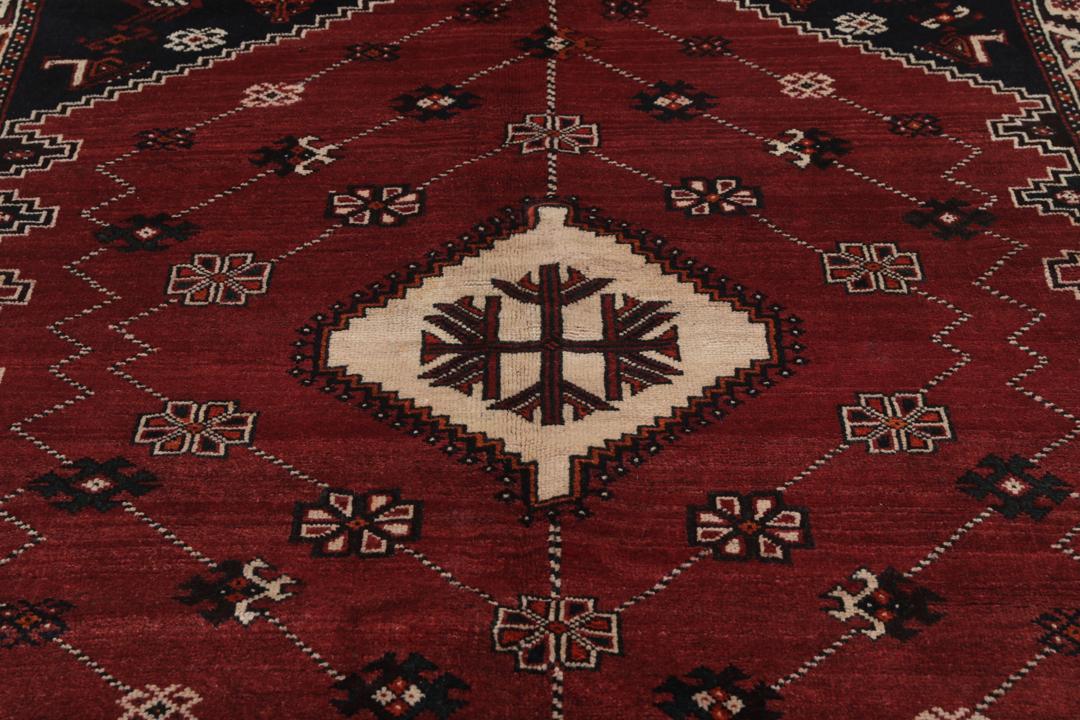 Hand-knotted Shiraz rug from the Middle East in dark-red and black tones.