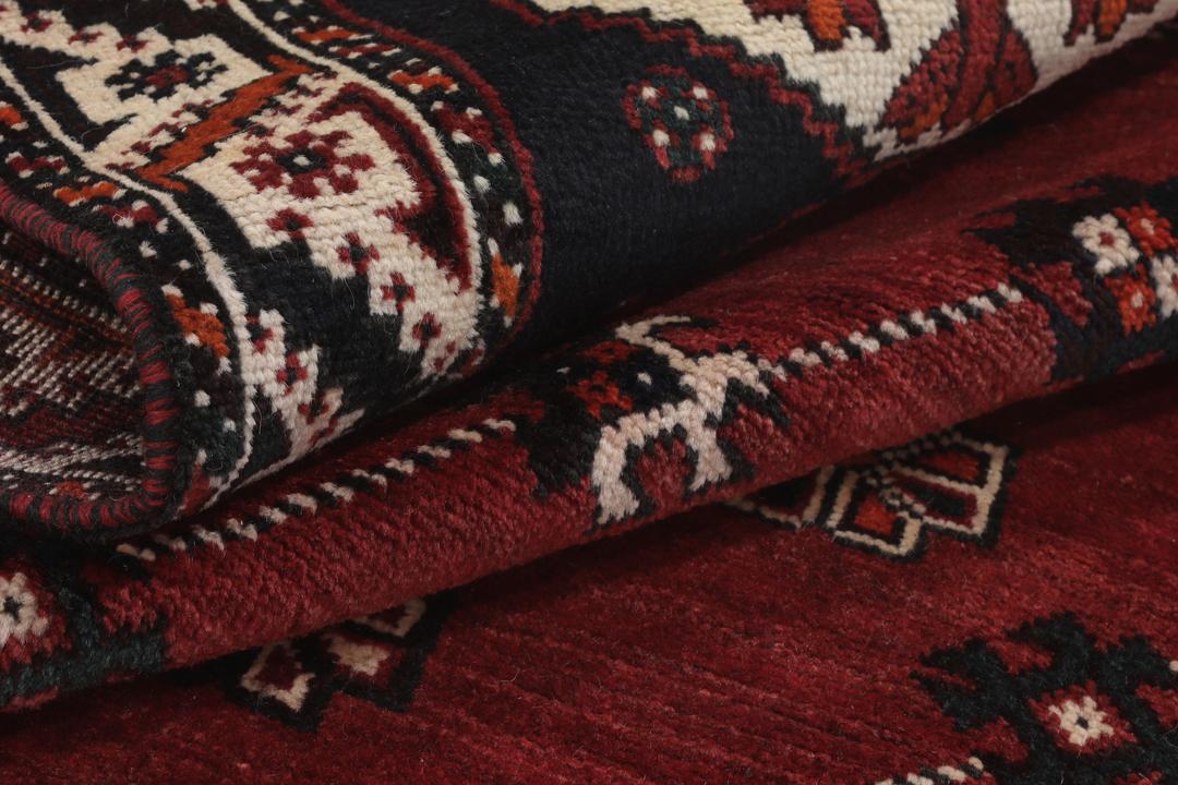 Hand-knotted Shiraz rug from the Middle East in dark-red and black tones.