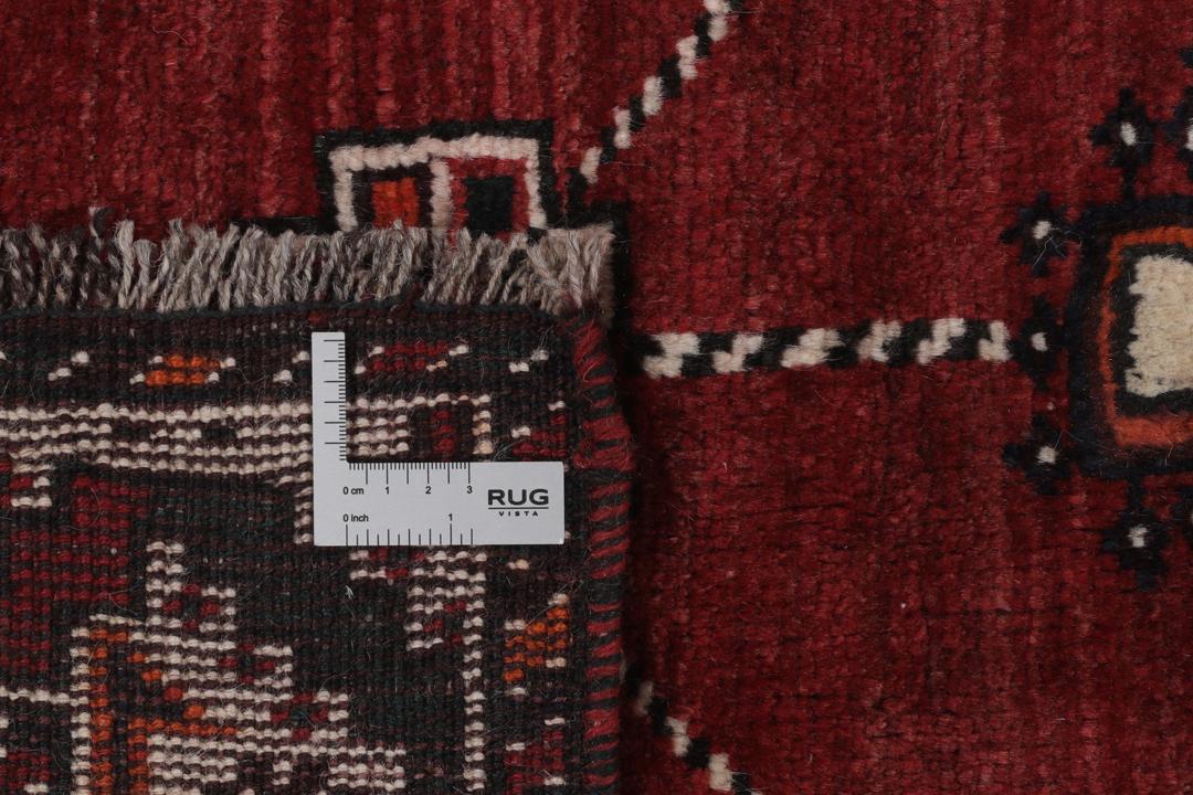Hand-knotted Shiraz rug from the Middle East in dark-red and black tones.