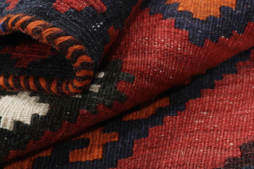 Tapis kilim vintage tissé à la main provenant du Moyen-Orient dans des tons rouge profond et géométriques contrastés