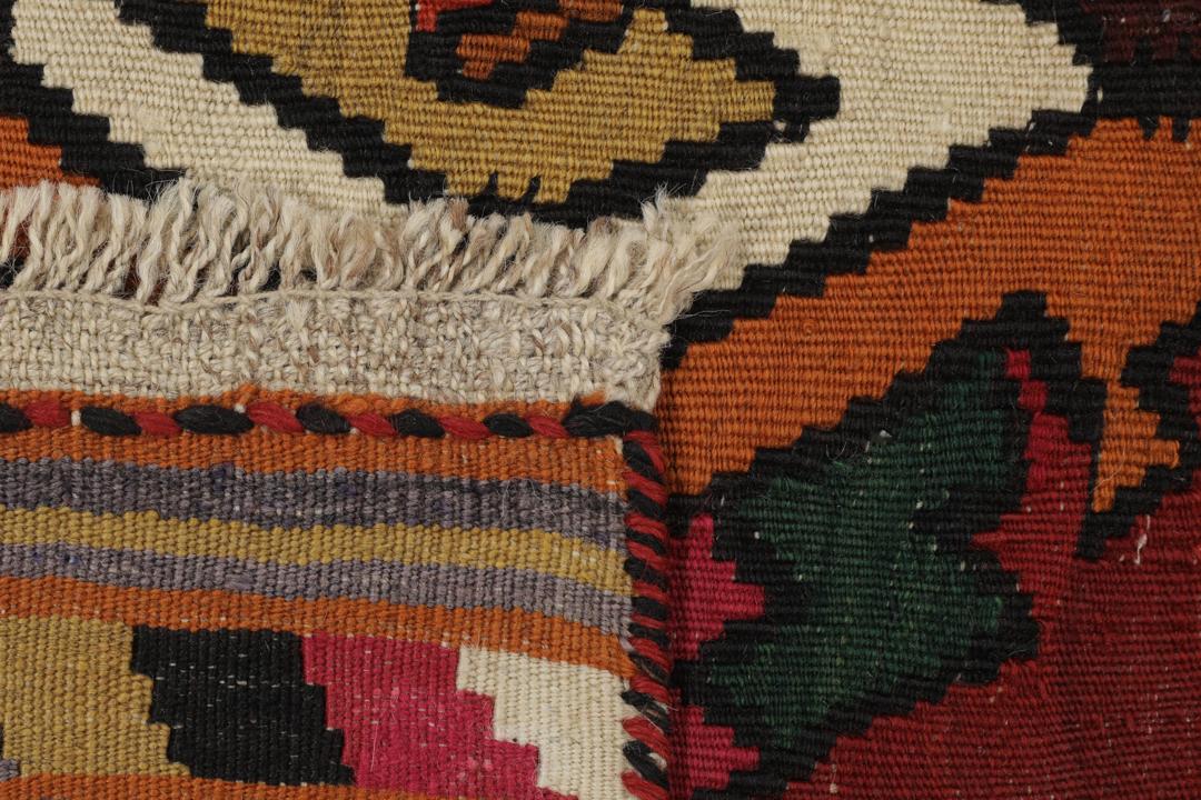 Un tapis kilim vintage tissé à la main provenant du Moyen-Orient, de couleur rouge profond avec des motifs géométriques