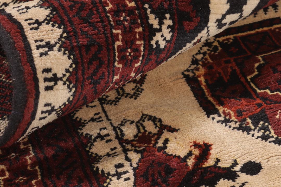 Handgeknoopt Kunduz-tapijt uit Afghanistan in rode en beige tinten.