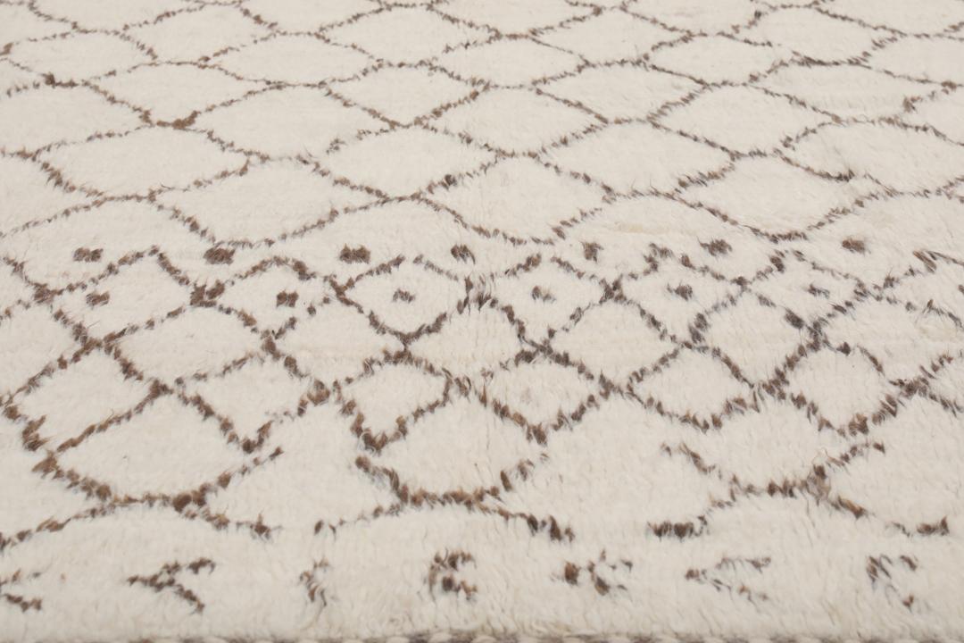 Een handgeknoopt kleed in Berberstijl uit Afghanistan met een neutraal beige en bruin geometrisch patroon.