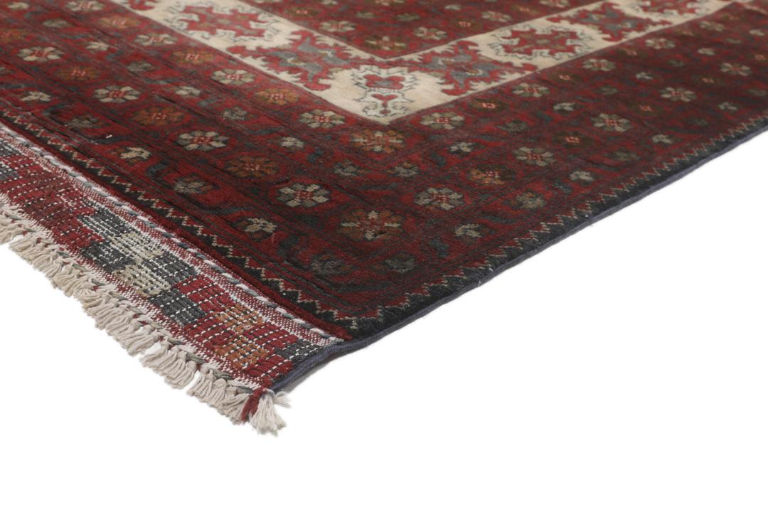 A hand-knotted Kunduz rug from Afghanistan with a red and beige colour palette.