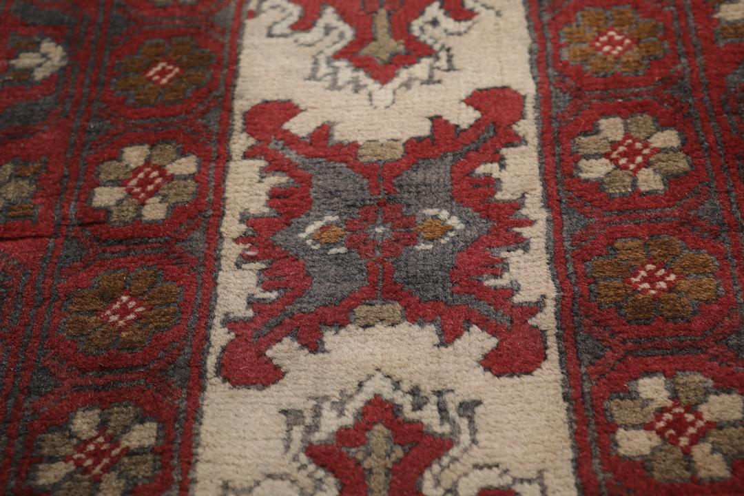 A hand-knotted Kunduz rug from Afghanistan with a red and beige colour palette.