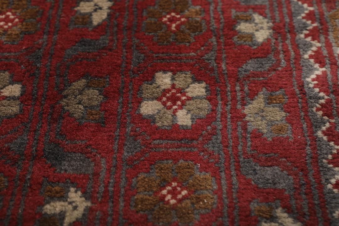 A hand-knotted Kunduz rug from Afghanistan with a red and beige colour palette.