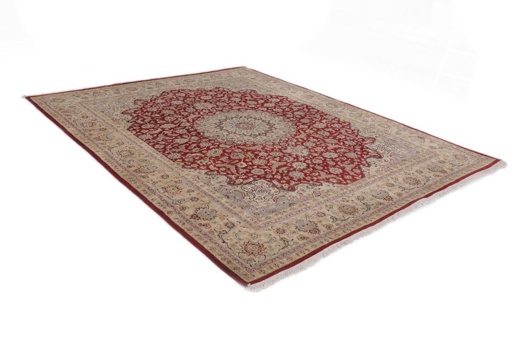 A large hand-knotted Tabriz rug from India with a red field and cream floral border.