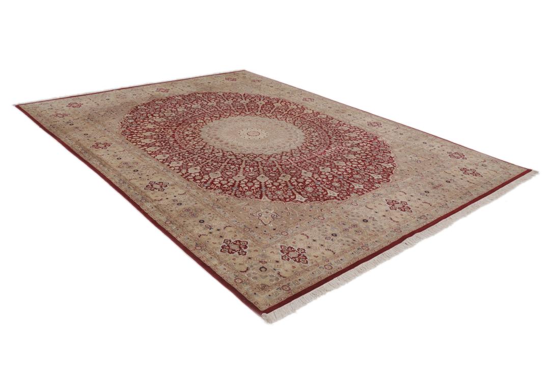 A hand-knotted Tabriz Royal rug from India featuring a central red medallion on a beige field.
