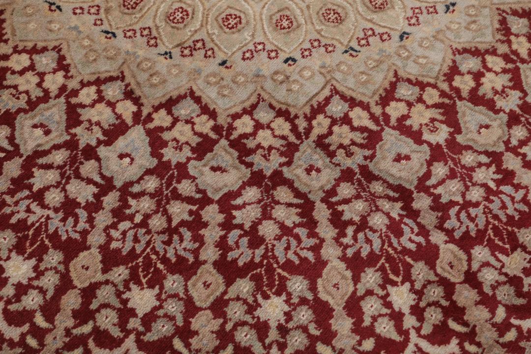 A hand-knotted Tabriz Royal rug from India featuring a central red medallion on a beige field.