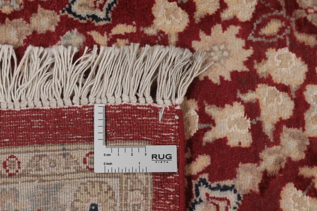 A hand-knotted Tabriz Royal rug from India featuring a central red medallion on a beige field.