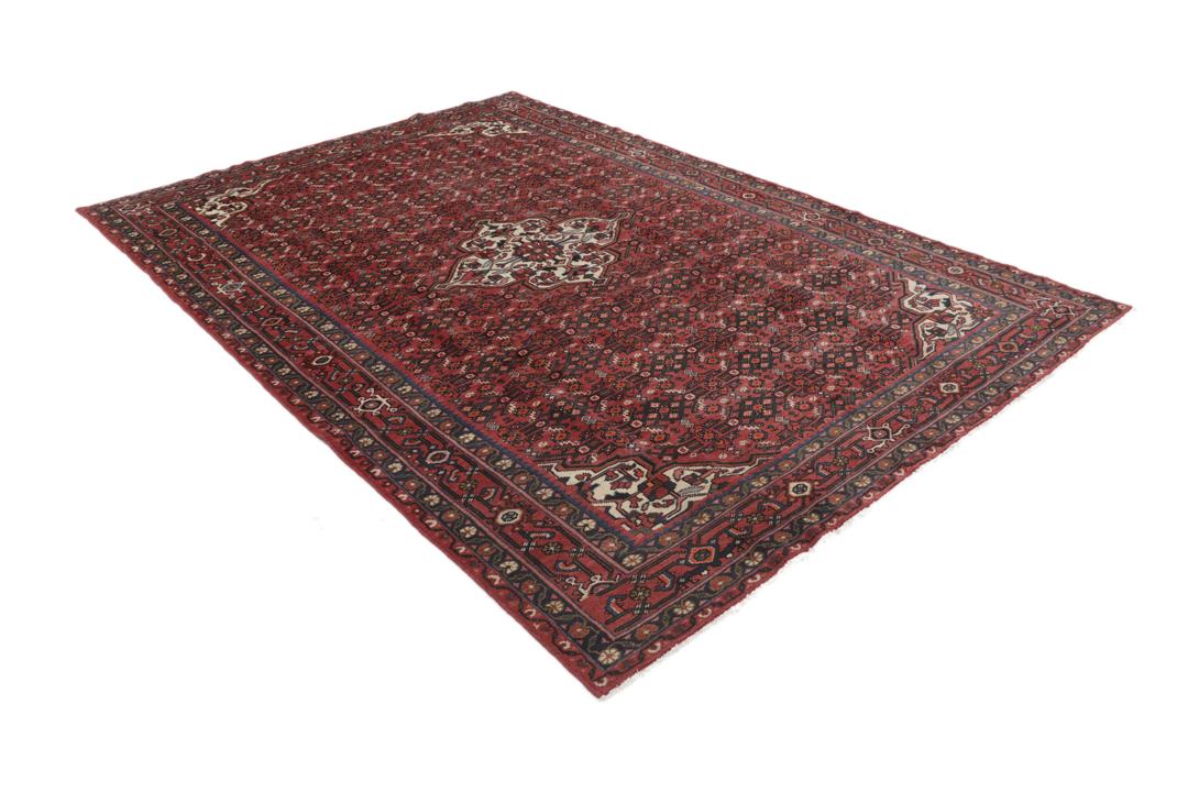 Hand-knotted Hosseinabad rug with red and dark-blue tones from the Middle East.