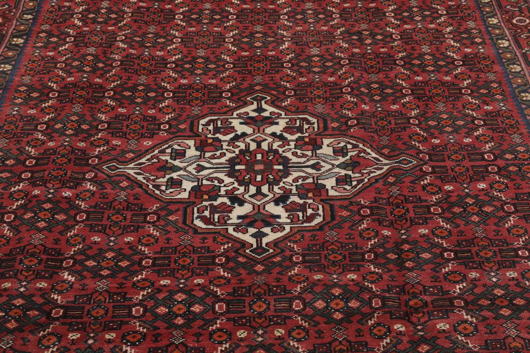 Hand-knotted Hosseinabad rug with red and dark-blue tones from the Middle East.