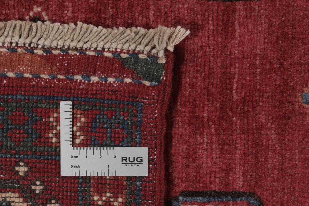 Handgeknoopt Kazak-tapijt uit Afghanistan in donkerrood met geometrische medaillonpatronen