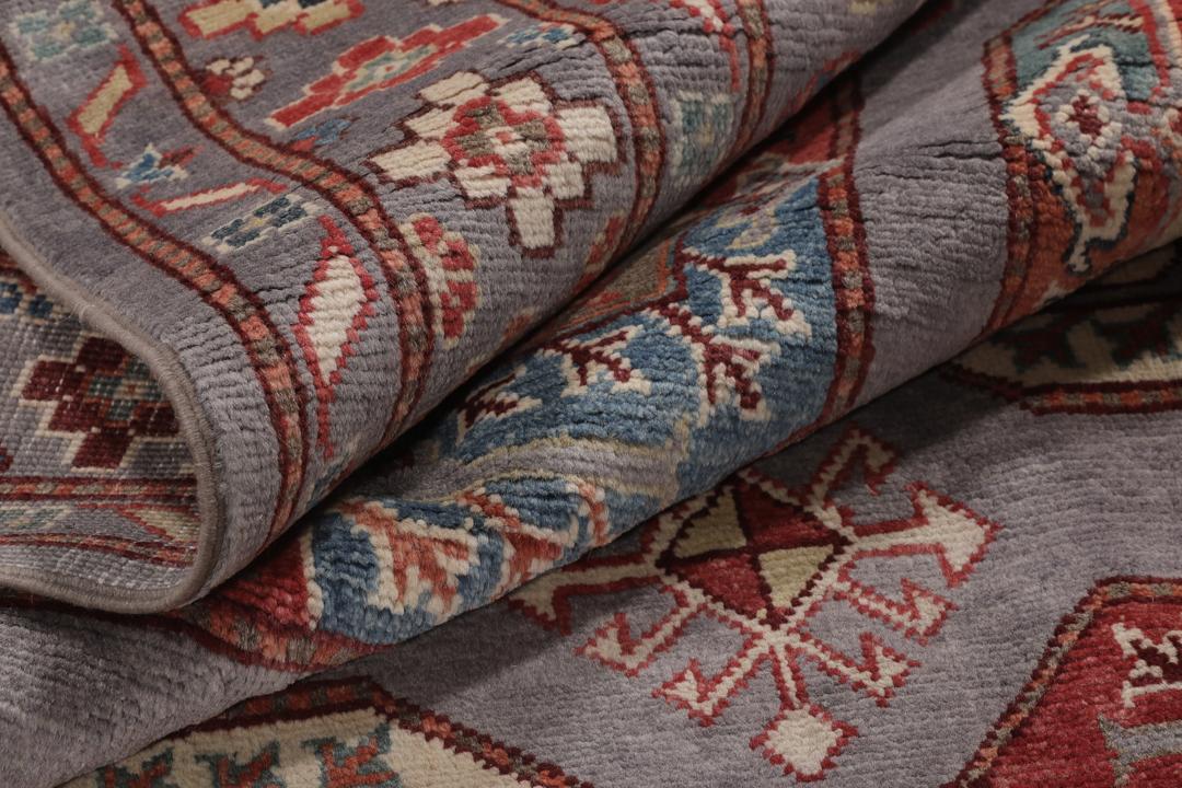 Hand-knotted Afghan Kazak rug with a grey field and geometric medallion motifs.