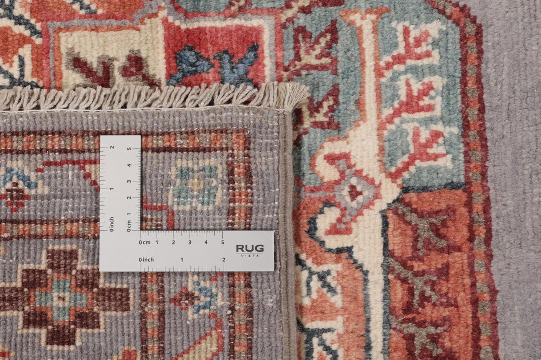 Hand-knotted Afghan Kazak rug with a grey field and geometric medallion motifs.