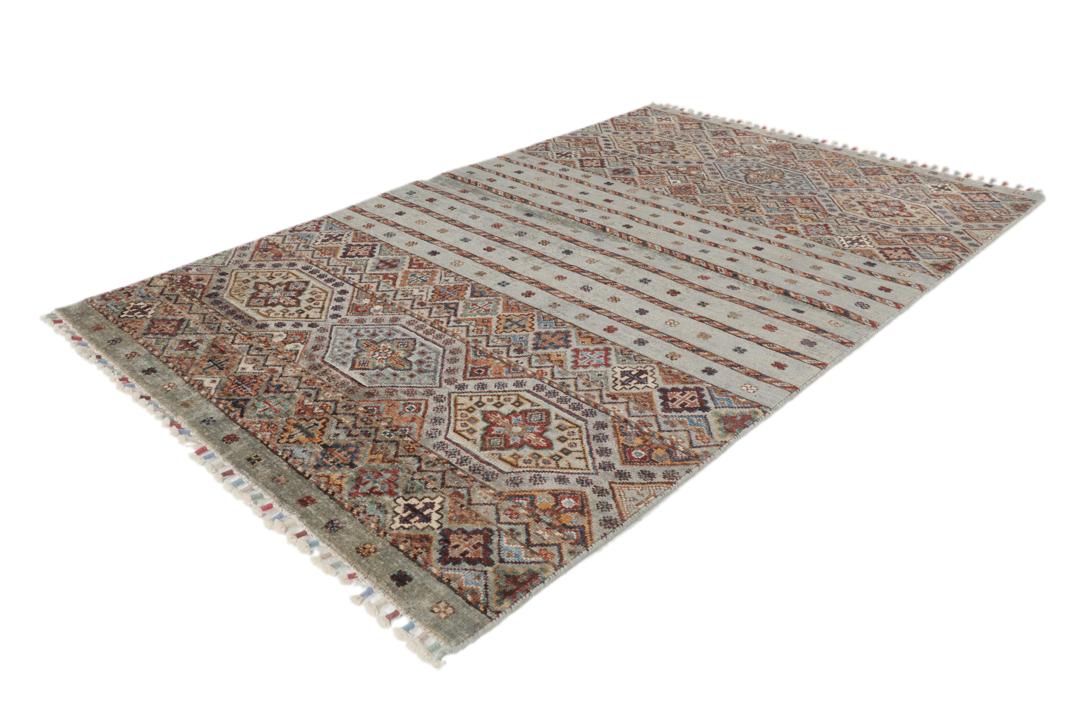 Una alfombra rectangular anudada a mano de Afganistán con una base verde y patrones geométricos