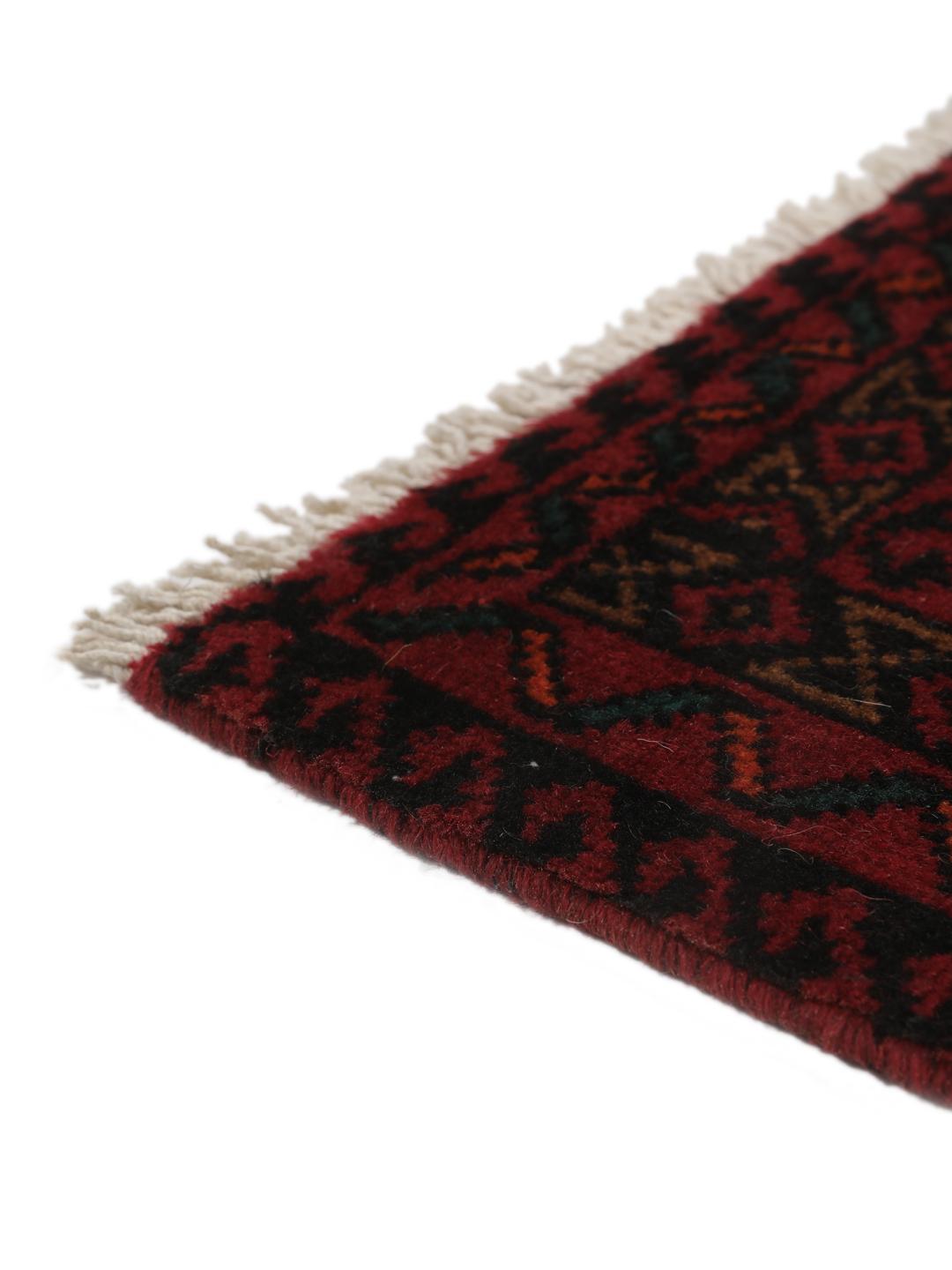 Hand-knotted Middle Eastern rug in red and cream tones