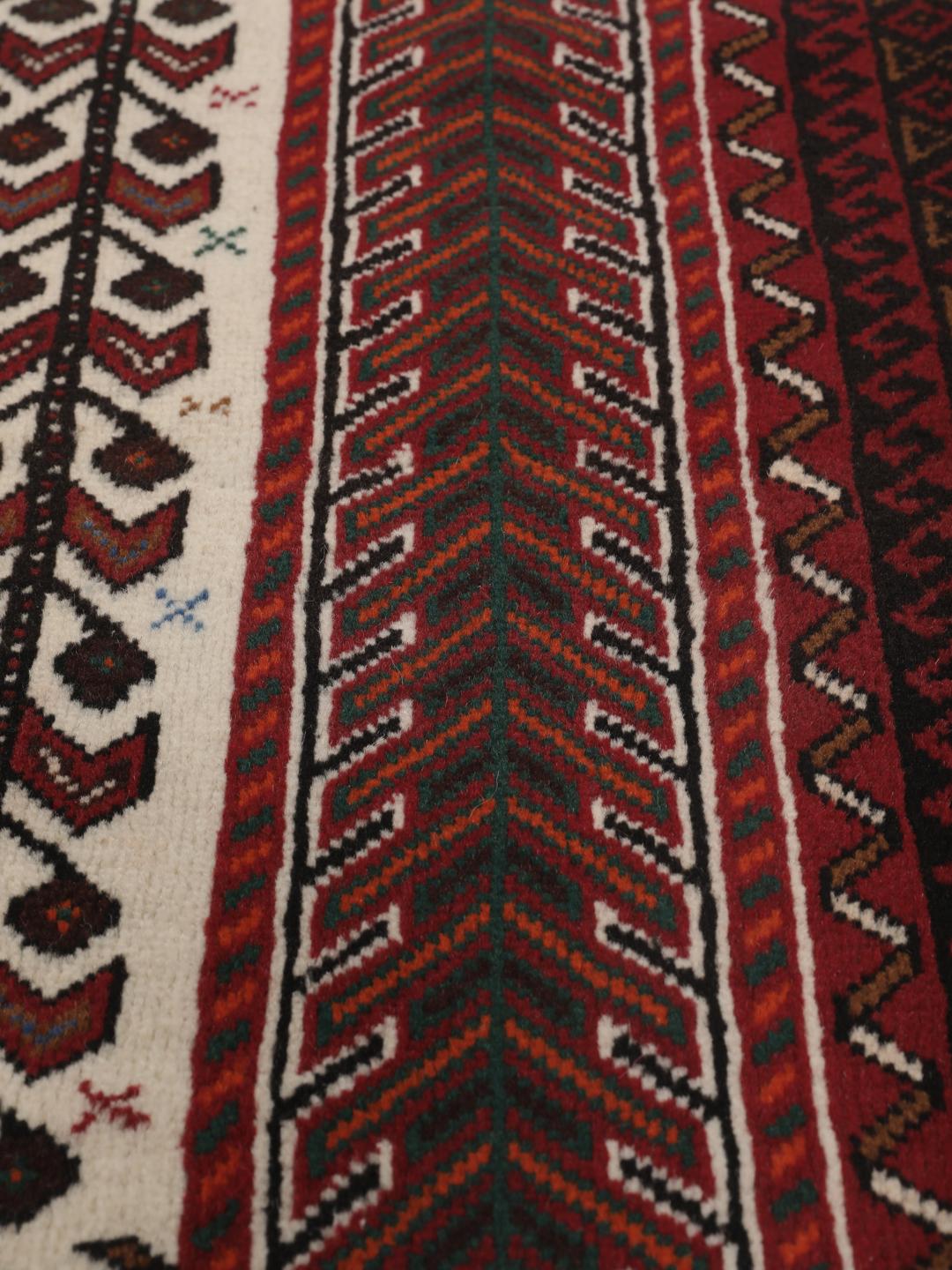 Hand-knotted Middle Eastern rug in red and cream tones