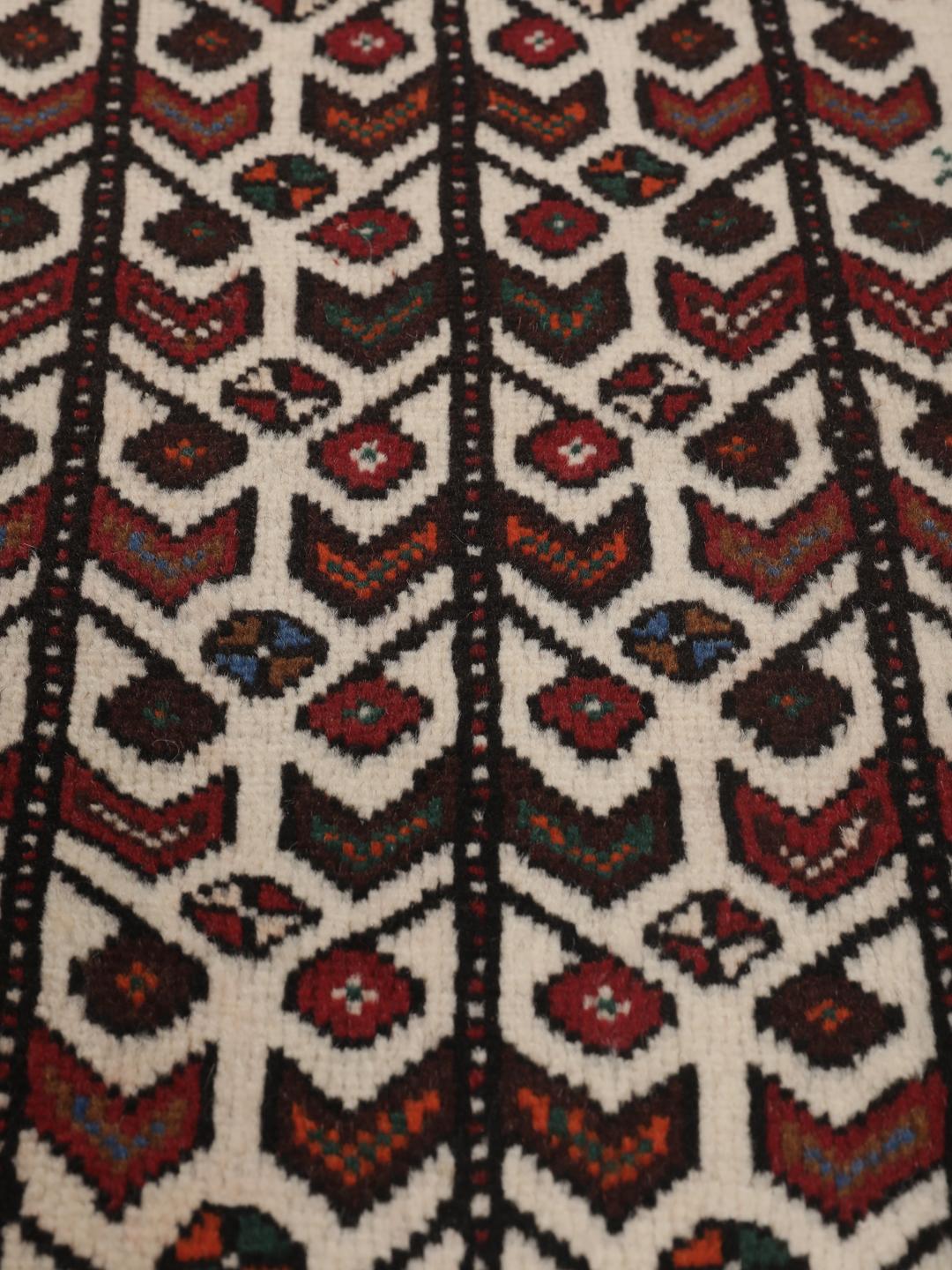 Hand-knotted Middle Eastern rug in red and cream tones