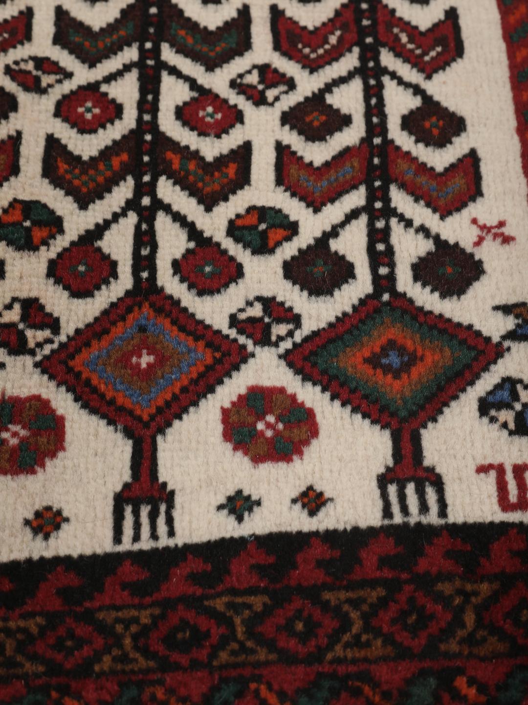 Hand-knotted Middle Eastern rug in red and cream tones