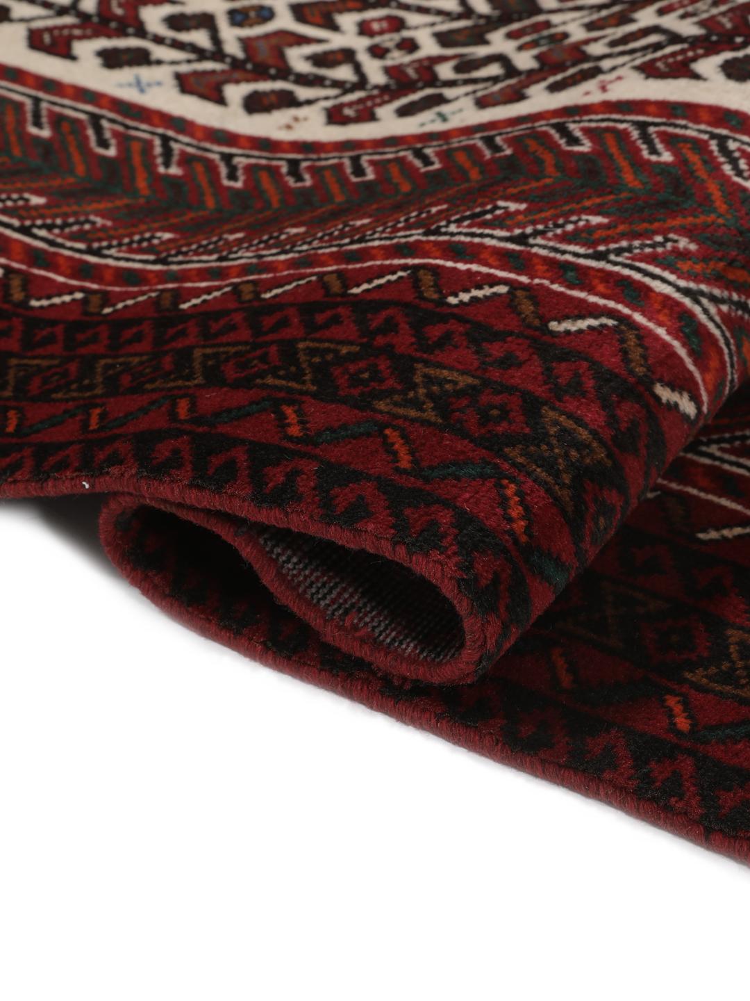 Hand-knotted Middle Eastern rug in red and cream tones