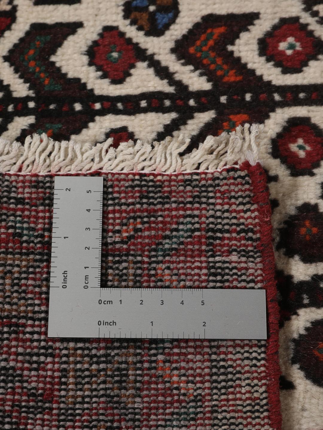 Hand-knotted Middle Eastern rug in red and cream tones