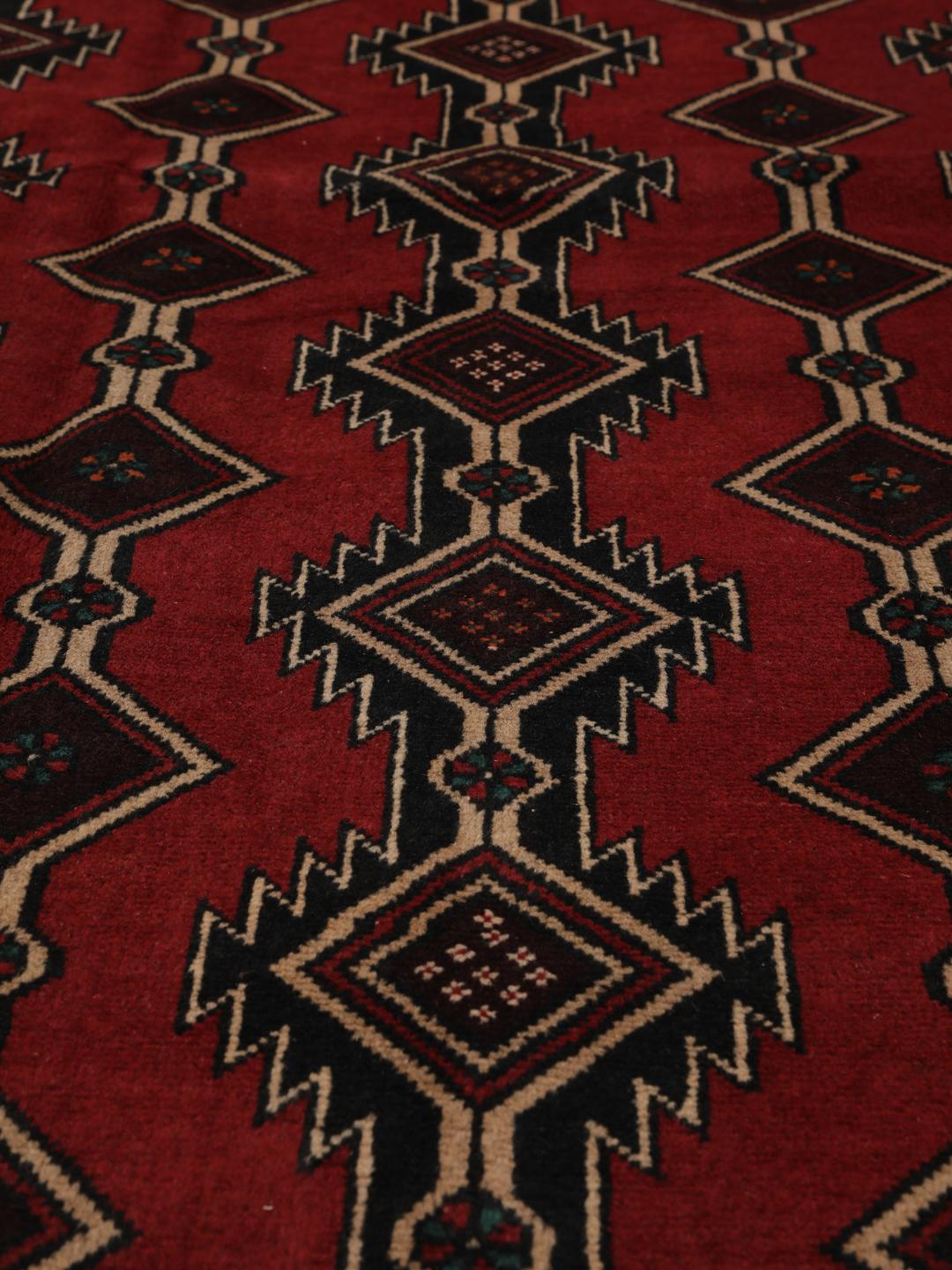Hand-knotted Middle Eastern Baluch rug in dark red with geometric patterns