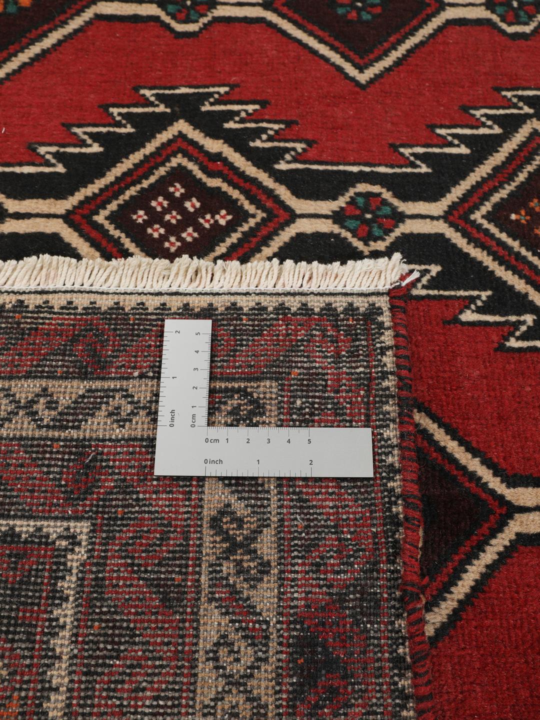 Hand-knotted Middle Eastern Baluch rug in dark red with geometric patterns