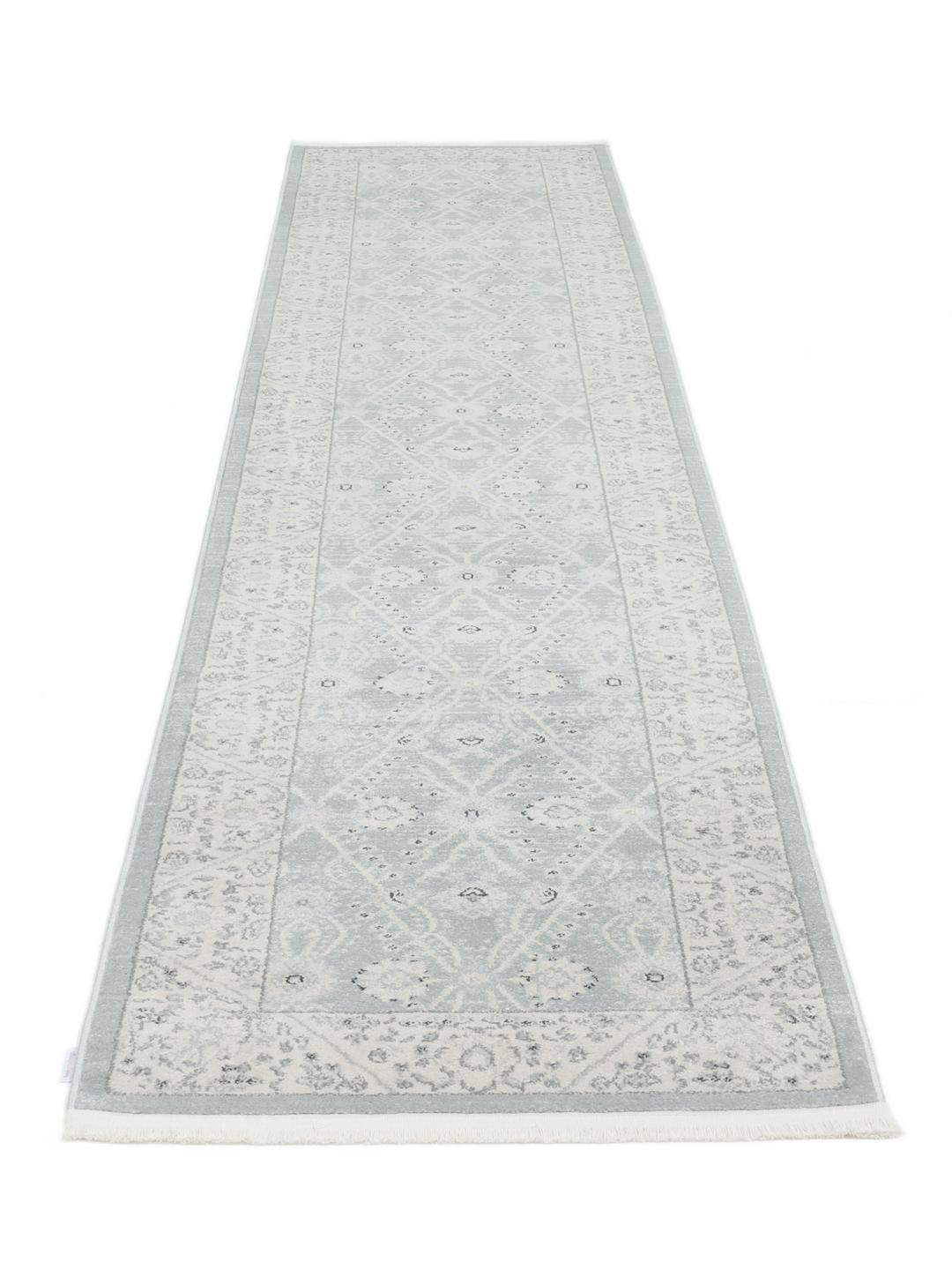 Lyseblå løbertæppe med traditionelle motiver
