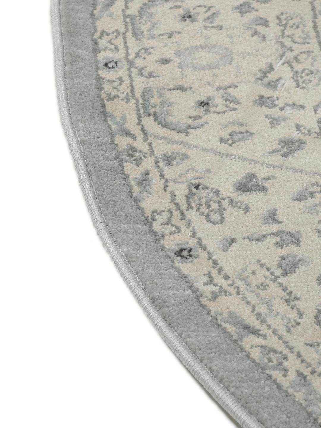 Rond vloerkleed in lichtblauw en crèmekleurig beige met een traditioneel patroon
