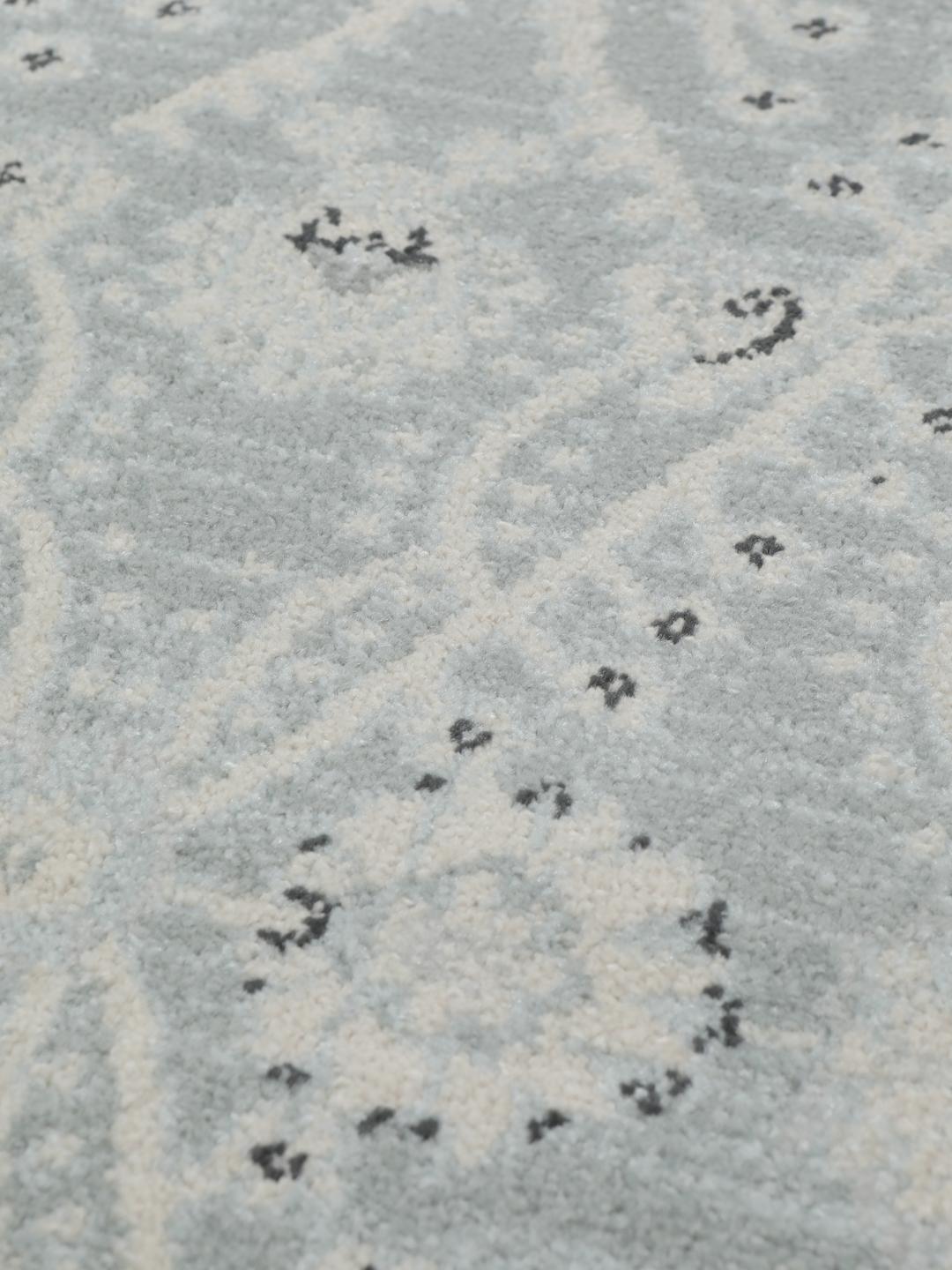 Rond vloerkleed in lichtblauw en crèmekleurig beige met een traditioneel patroon
