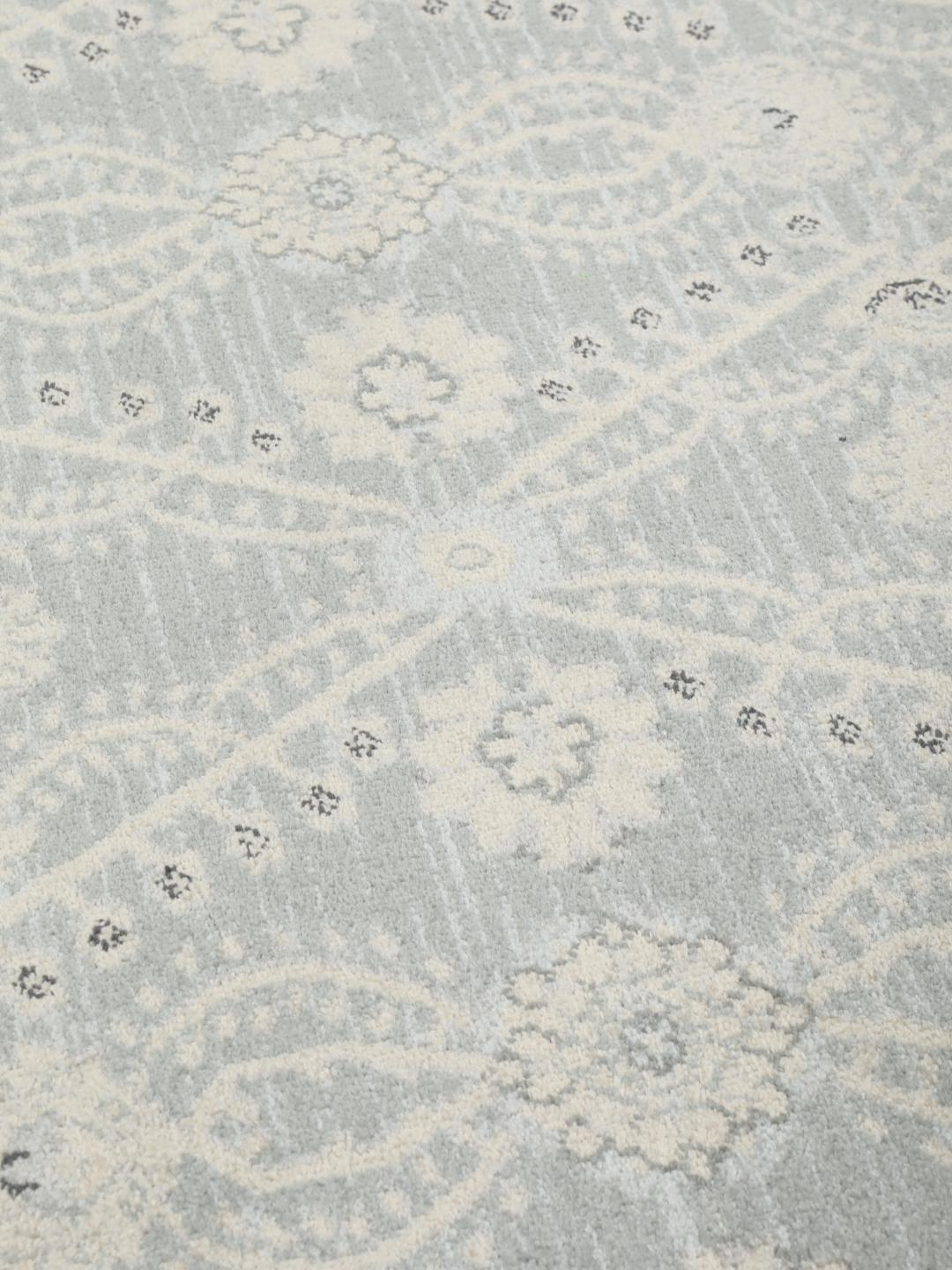 Rond vloerkleed in lichtblauw en crèmekleurig beige met een traditioneel patroon
