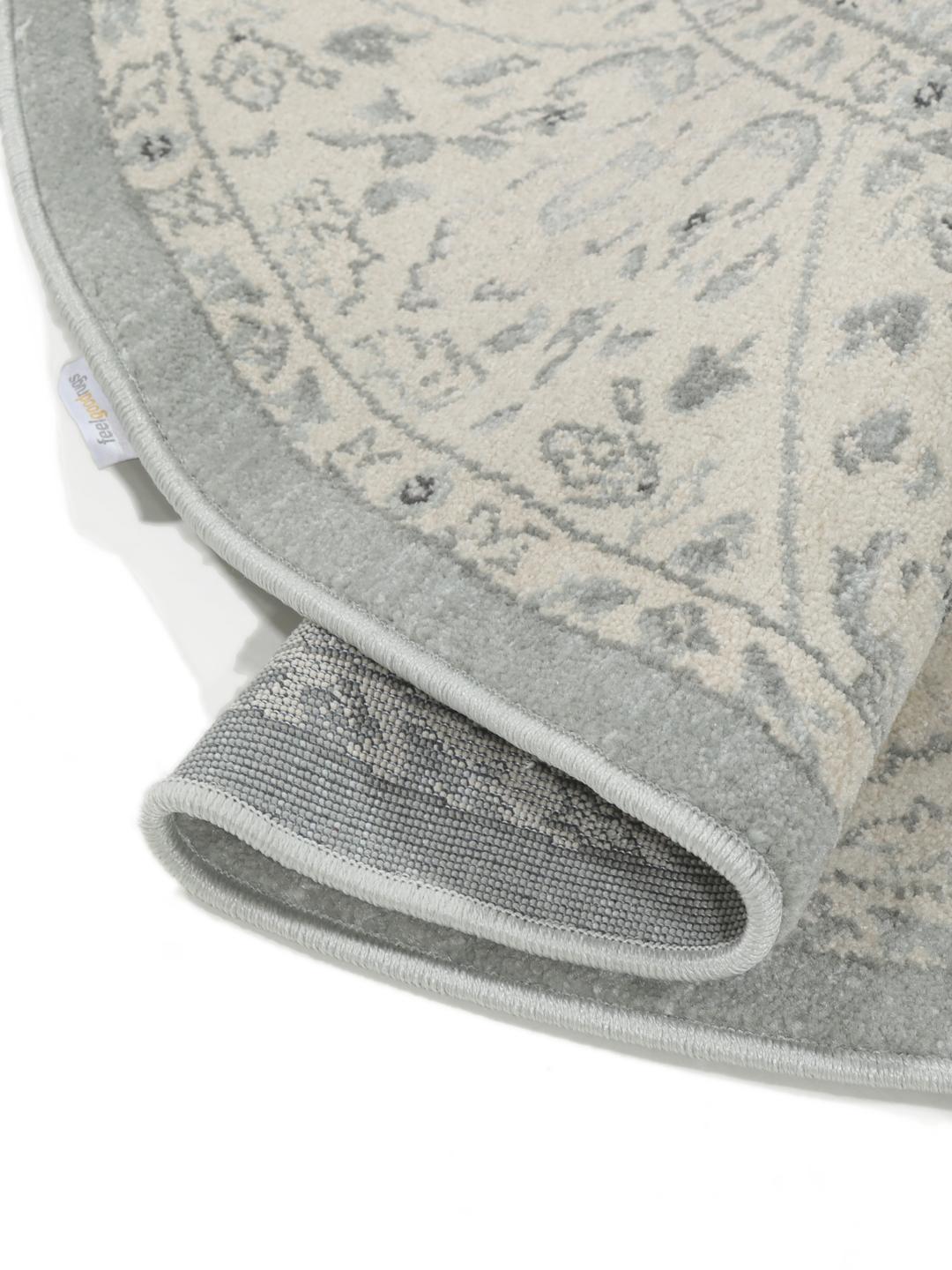 Rond vloerkleed in lichtblauw en crèmekleurig beige met een traditioneel patroon
