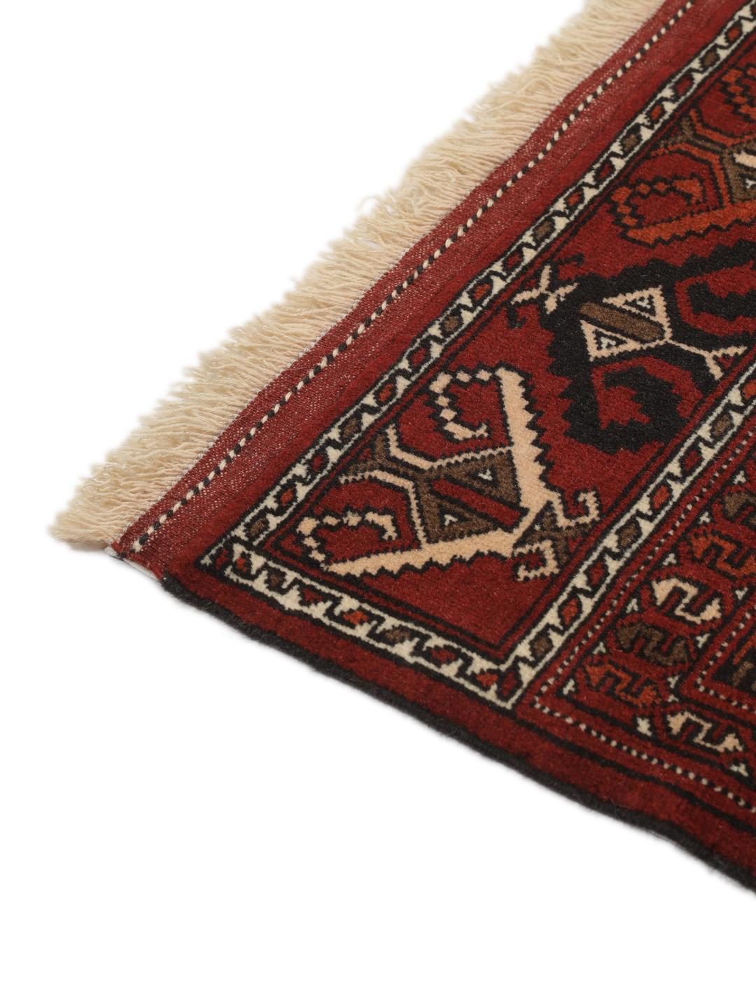 Hand-knotted Turkaman rug from the Middle East featuring a vibrant red and cream colour palette