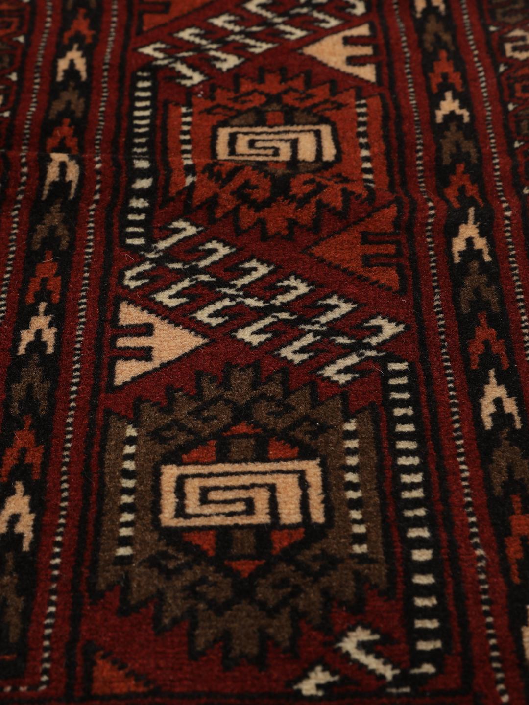 Hand-knotted Turkaman rug from the Middle East featuring a vibrant red and cream colour palette