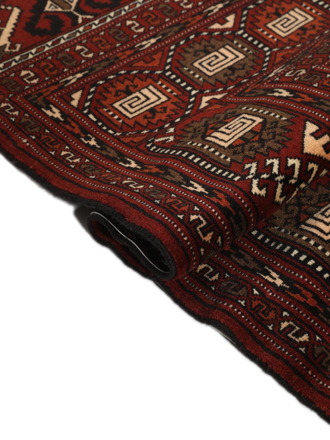 Hand-knotted Turkaman rug from the Middle East featuring a vibrant red and cream colour palette