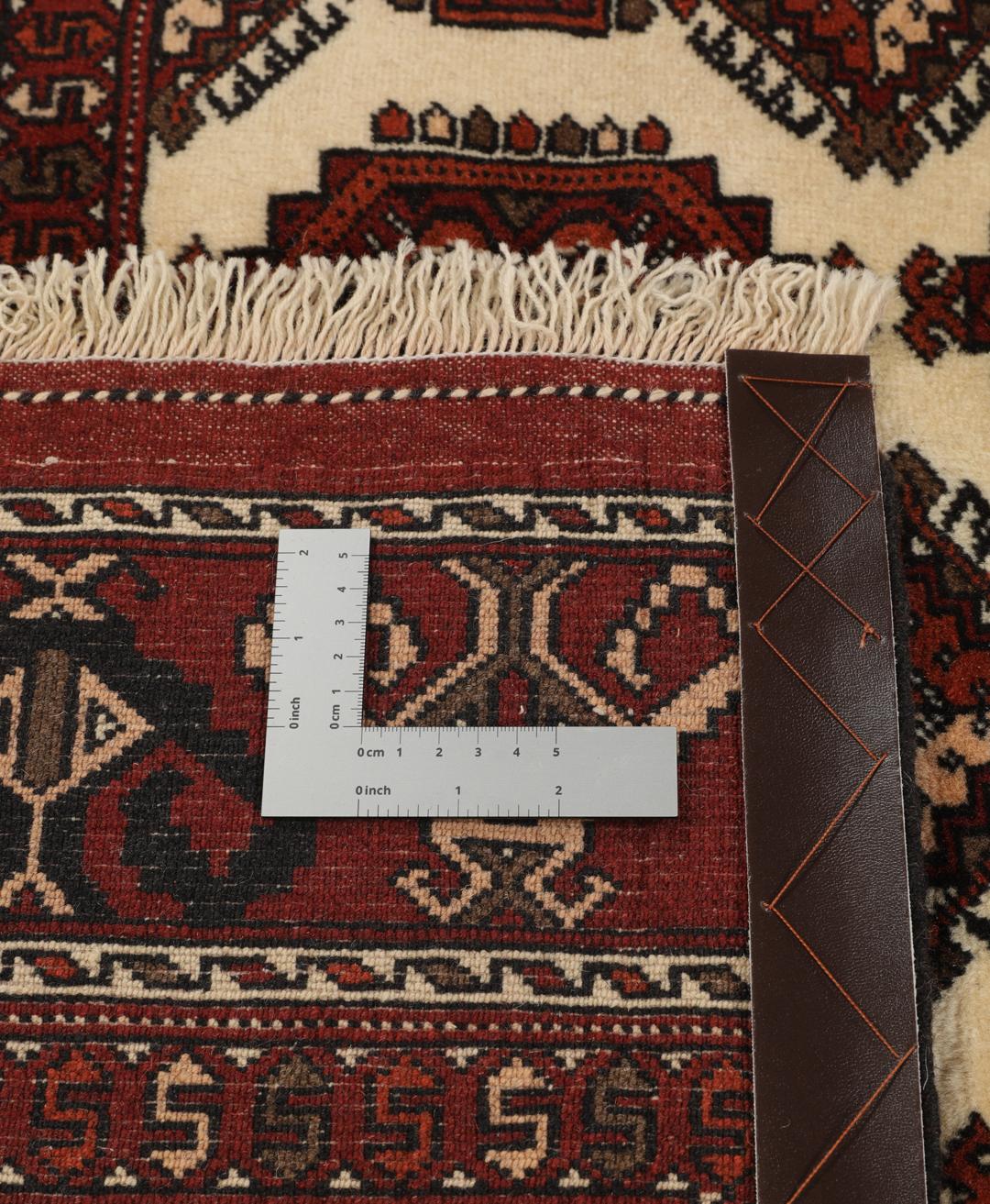 Hand-knotted Turkaman rug from the Middle East featuring a vibrant red and cream colour palette