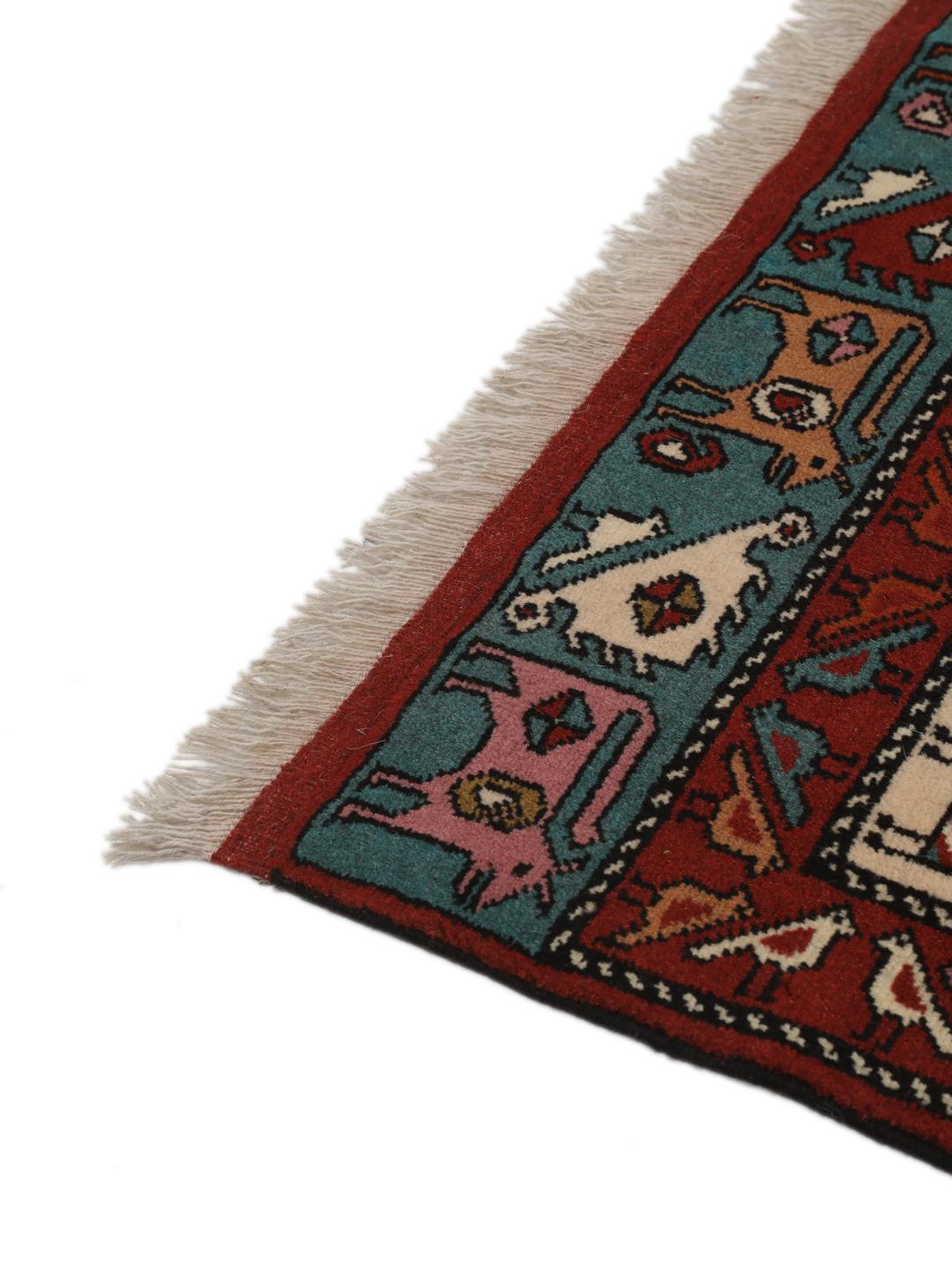 Hand-knotted Middle Eastern rug in red wool with pictorial motifs