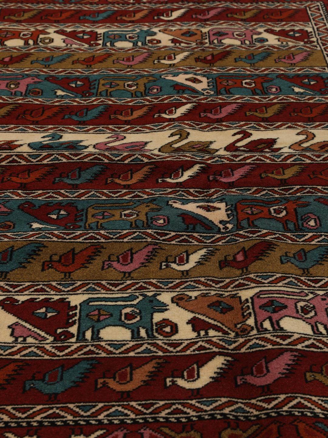 Hand-knotted Middle Eastern rug in red wool with pictorial motifs