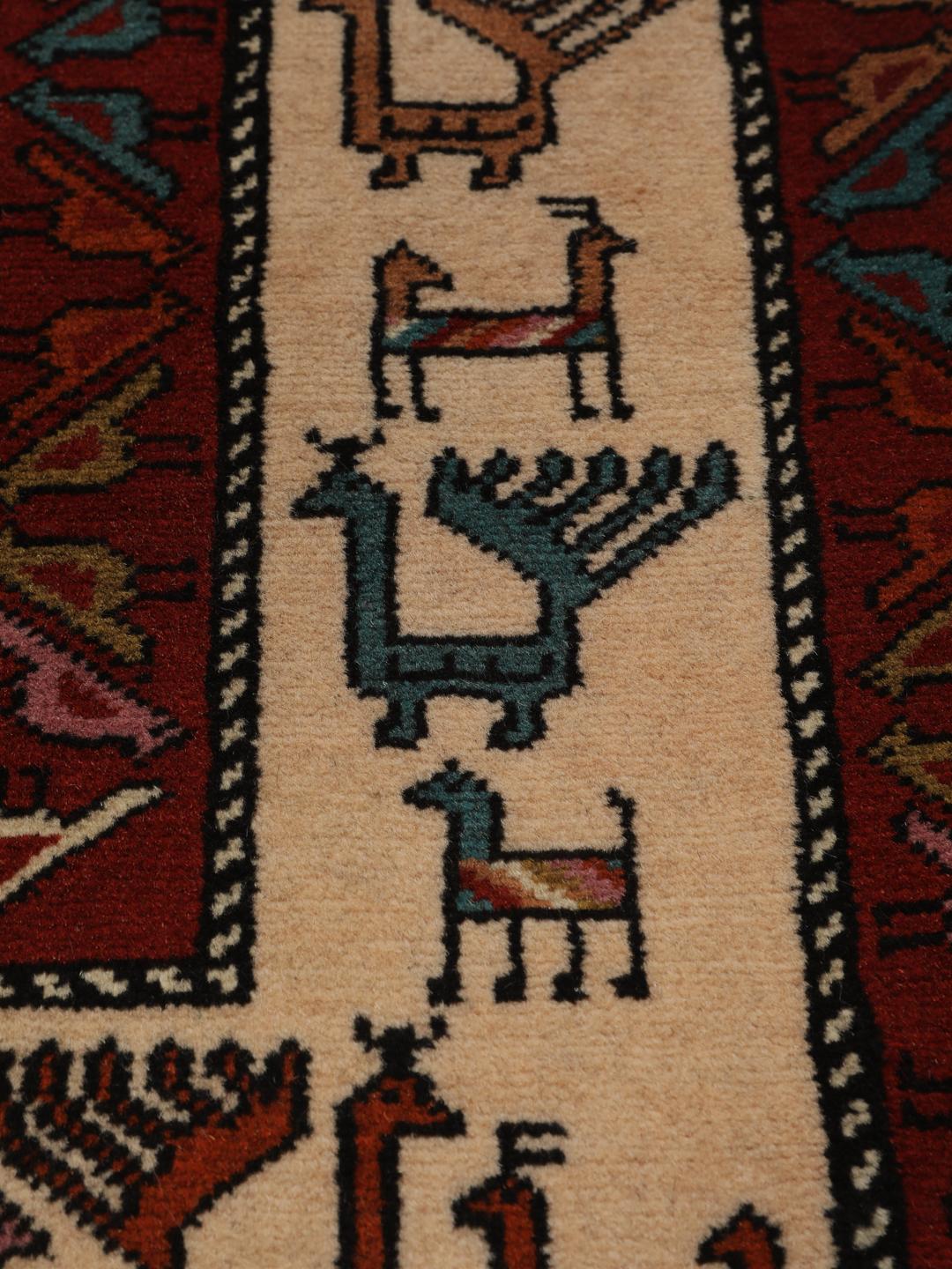 Hand-knotted Middle Eastern rug in red wool with pictorial motifs