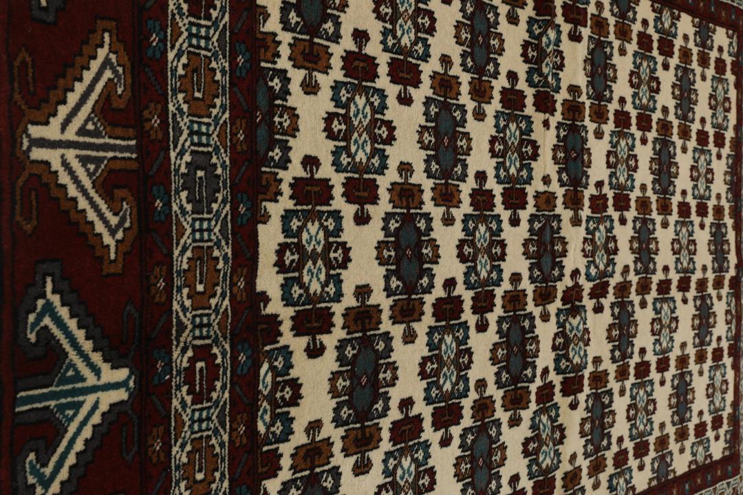 Hand-knotted Middle Eastern Turkaman wool rug in red and beige